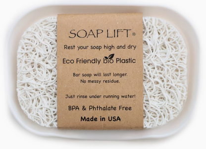 Soap lift pad and informational cardboard insert inside a soap dish.