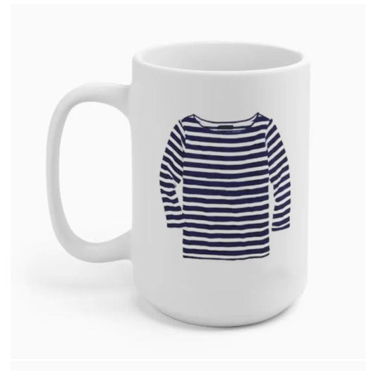A white mug with an illustration of a navy blue and white striped long-sleeve shirt on its surface.
