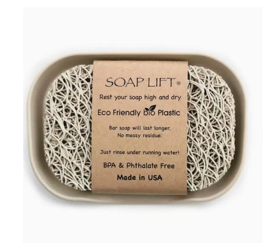 A soap saver pad inside a tray with an informational card detailing the product's benefits, including eco-friendly design, mess reduction, and being bpa &amp; phthalate free, all made in the usa.