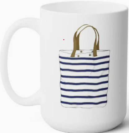 A white coffee mug with an illustration of a striped tote bag.