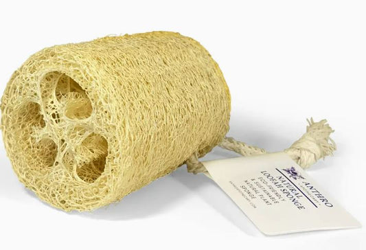 Natural fibrous loofah sponge with attached brand tag on a white background.
